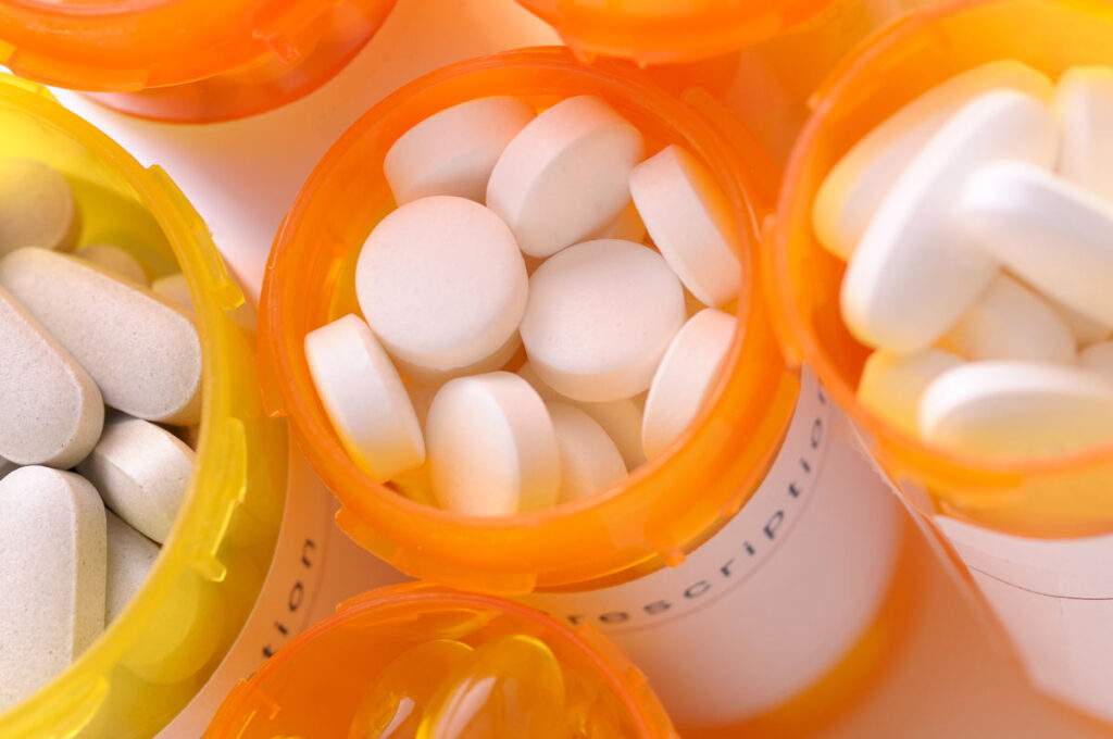 Close up of pill bottles containing medication tablets, representing the Invokana side effects settlement.