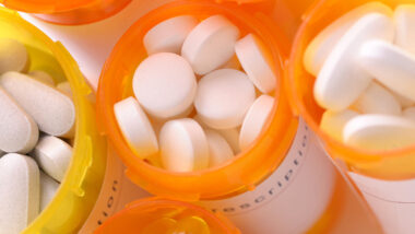 Close up of pill bottles containing medication tablets, representing the Invokana side effects settlement.