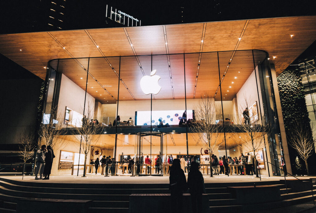 Exterior of an Apple Store at night, representing the AppleCare warranty settlement.