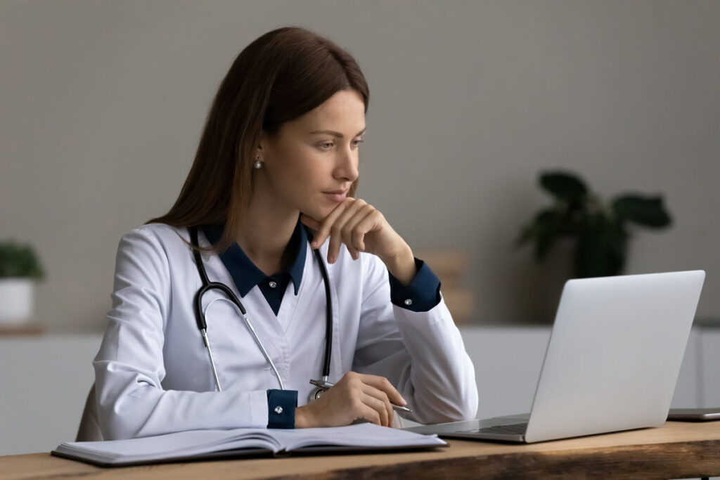 A medical professional using a laptop, representing the Health Employers Association of British Columbia data breach.