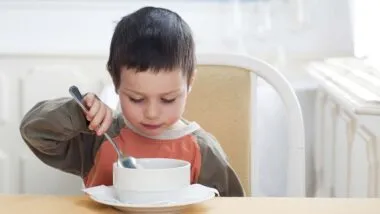 Young boy eating from a bowl, representing the Little Gourmet Organic Mealtime Bowls recall.