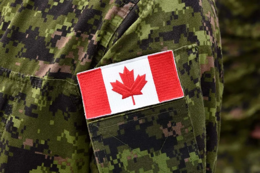 Close up of the Canadian flag on a military uniform, representing the Veterans Affairs Canada disability pension miscalculation settlement.