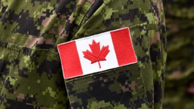 Close up of the Canadian flag on a military uniform, representing the Veterans Affairs Canada disability pension miscalculation settlement.