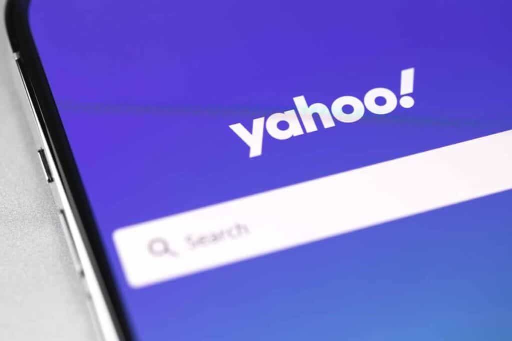Close up of Yahoo logo and search bar displayed on a smartphone, representing the Yahoo settlement.