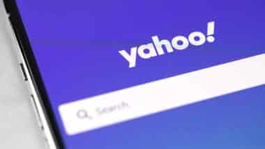 Close up of Yahoo logo and search bar displayed on a smartphone, representing the Yahoo settlement.