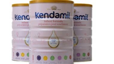 Three cans of Kendamill baby formula.