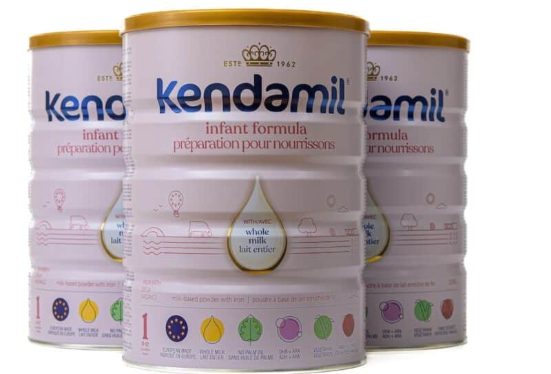Three cans of Kendamill baby formula.