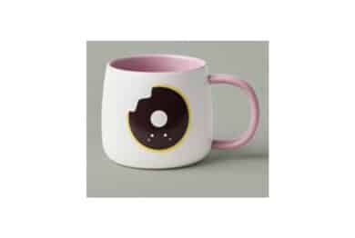 16oz white ceramic mug with a donut design on the front and back of the product.